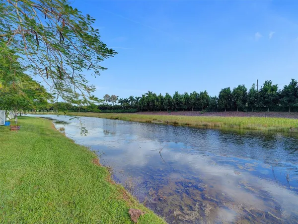 a view of a lake with houses in the back