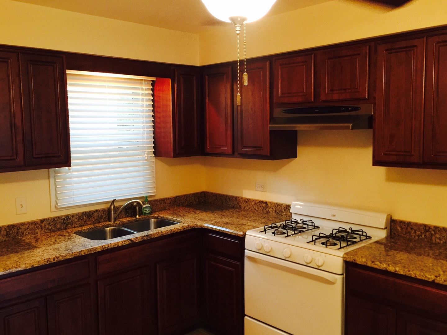 2290 182nd Place Lansing, IL 60438 - Photo 6 of 16 a kitchen with wooden cabinets and a stove top oven