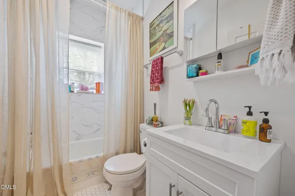 a kitchen with white cabinets stainless steel appliances and sink