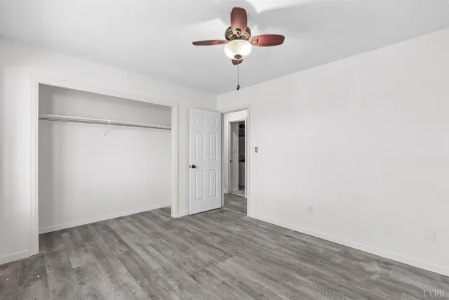a view of room with hardwood floor and ceiling fan