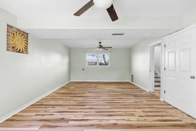 a view of a ceiling fan and wooden floor in a room