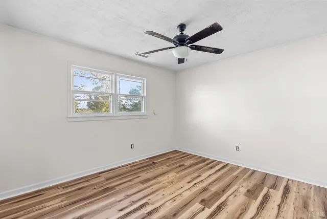 a view of a big room with wooden floor and closet