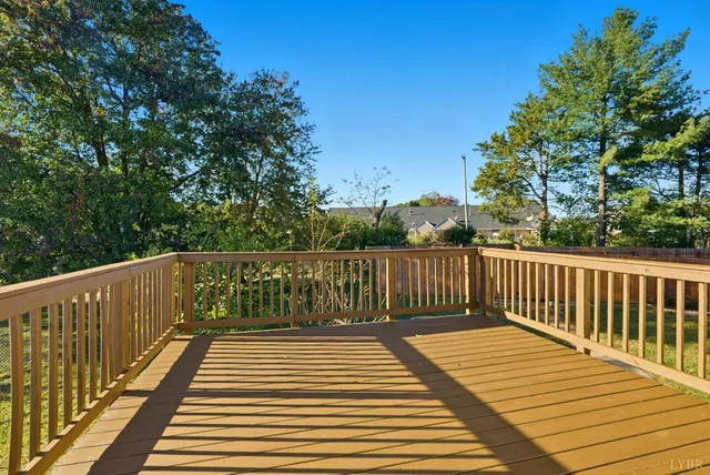a balcony with wooden floor and fence