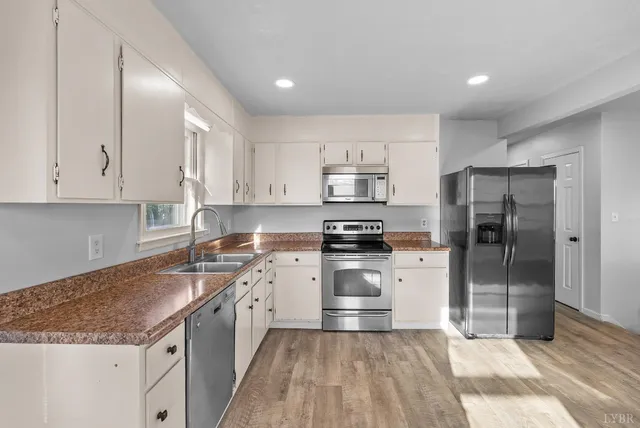 a kitchen with a sink stainless steel appliances and cabinets