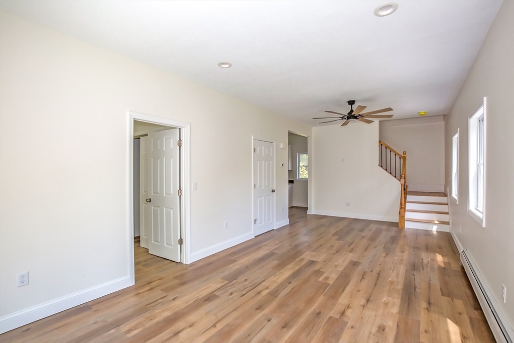 165 Sandisfield Road Sandisfield, MA 01255 - Photo 15 of 37 a view of empty room with wooden floor and fan