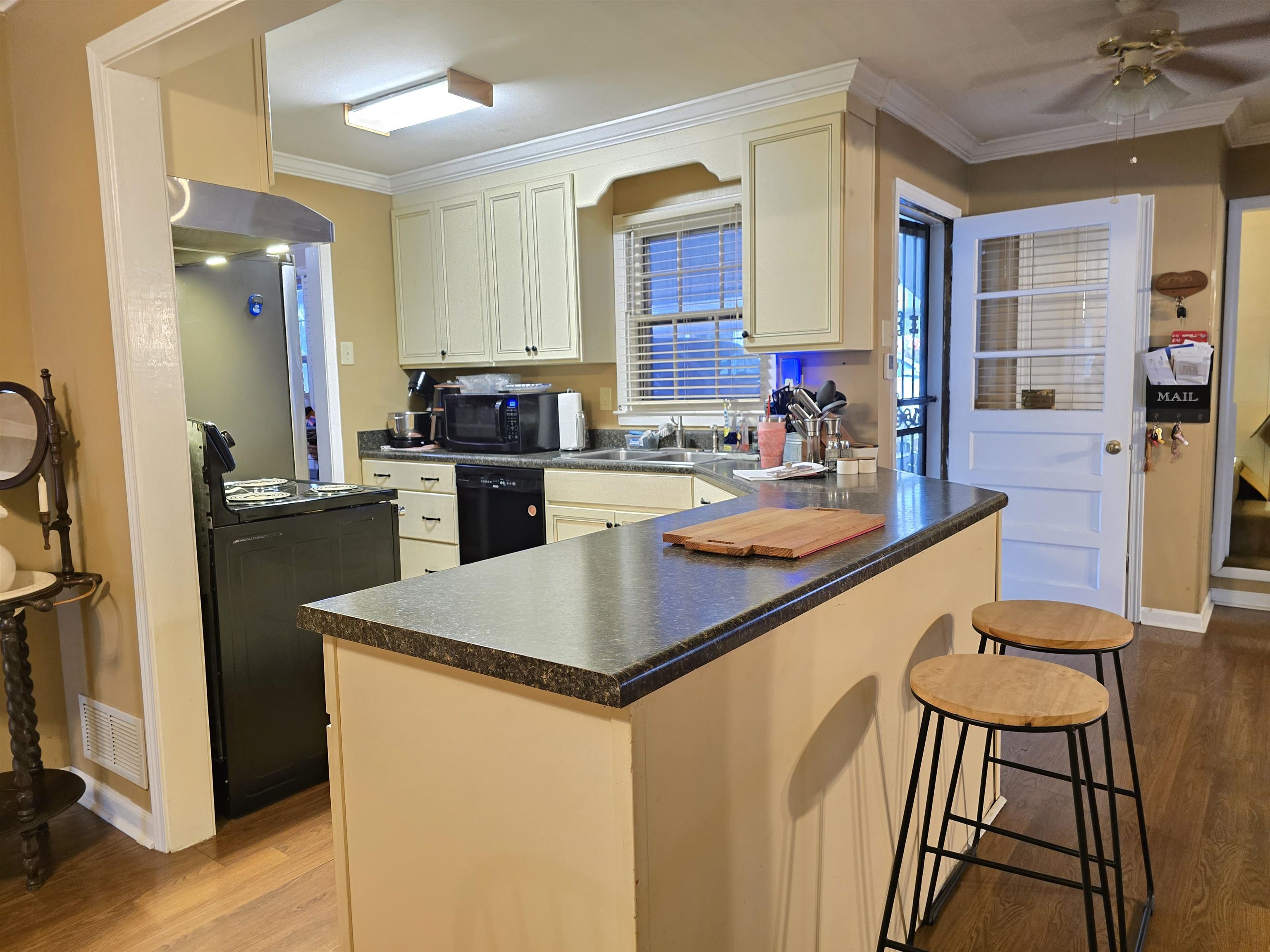 4885 Macon Road Memphis, TN 38122 - Photo 18 of 39 a kitchen with sink a refrigerator and chairs