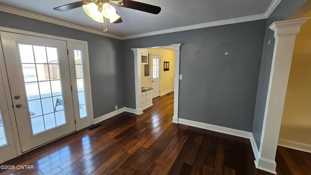 wooden floor in an empty room with a window