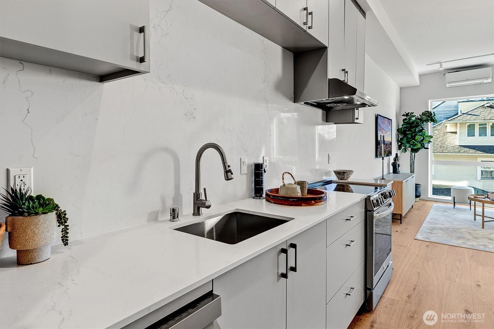 1227 East Roy Street Seattle, WA 98102 - Photo 17 of 35 a kitchen with a sink a stove and cabinets