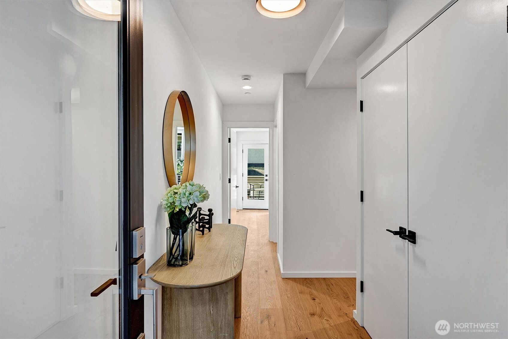 1227 East Roy Street Seattle, WA 98102 - Photo 2 of 35 a view of a hallway with wooden floor and a potted plant