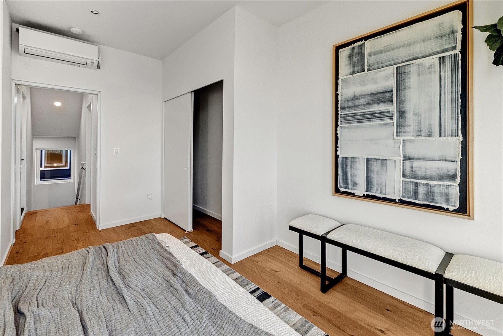 1227 East Roy Street Seattle, WA 98102 - Photo 22 of 35 a bedroom with a bed and wooden floor