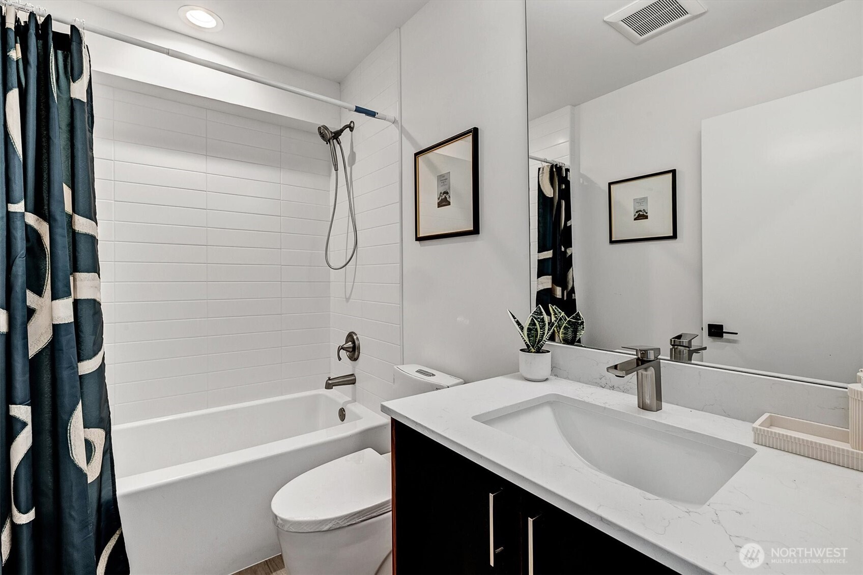 1227 East Roy Street Seattle, WA 98102 - Photo 6 of 35 a bathroom with a granite countertop sink toilet and shower
