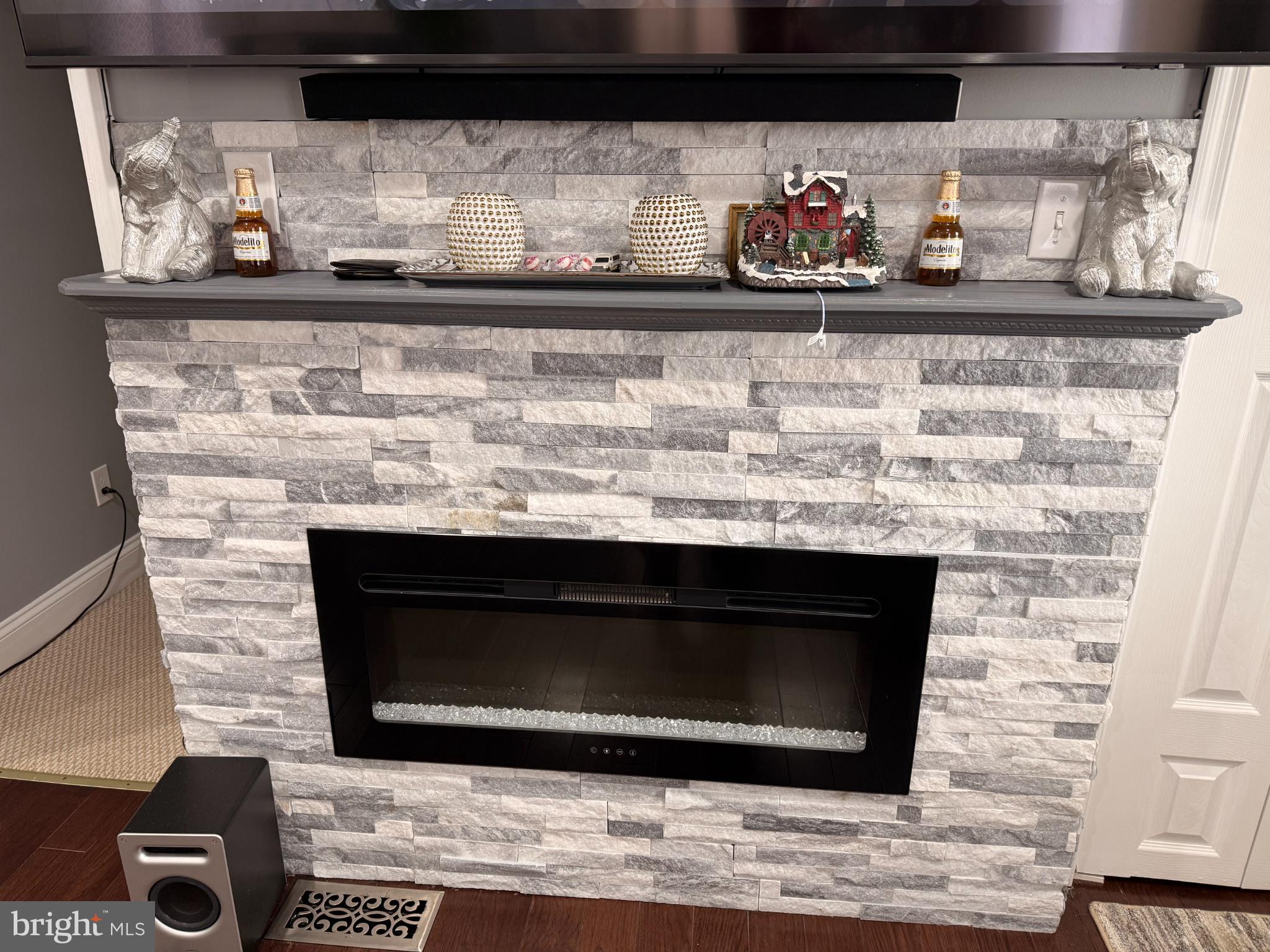 3499 Hillsmere Road Baltimore, MD 21207 - Photo 16 of 50 Modern stone fireplace with elegant decor.