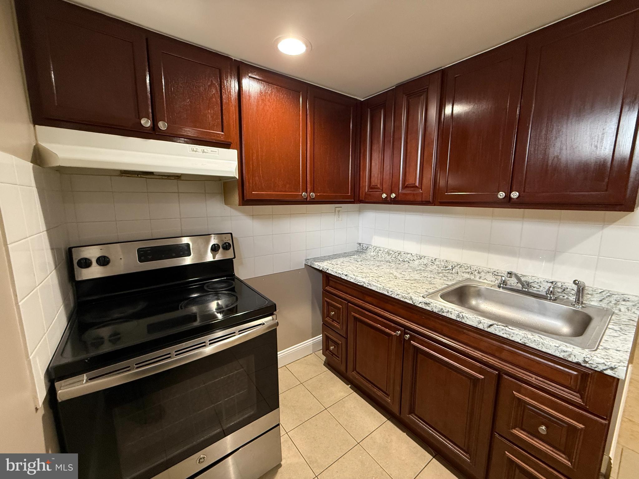 3499 Hillsmere Road Baltimore, MD 21207 - Photo 33 of 50 Charming kitchen with rich wood cabinetry.