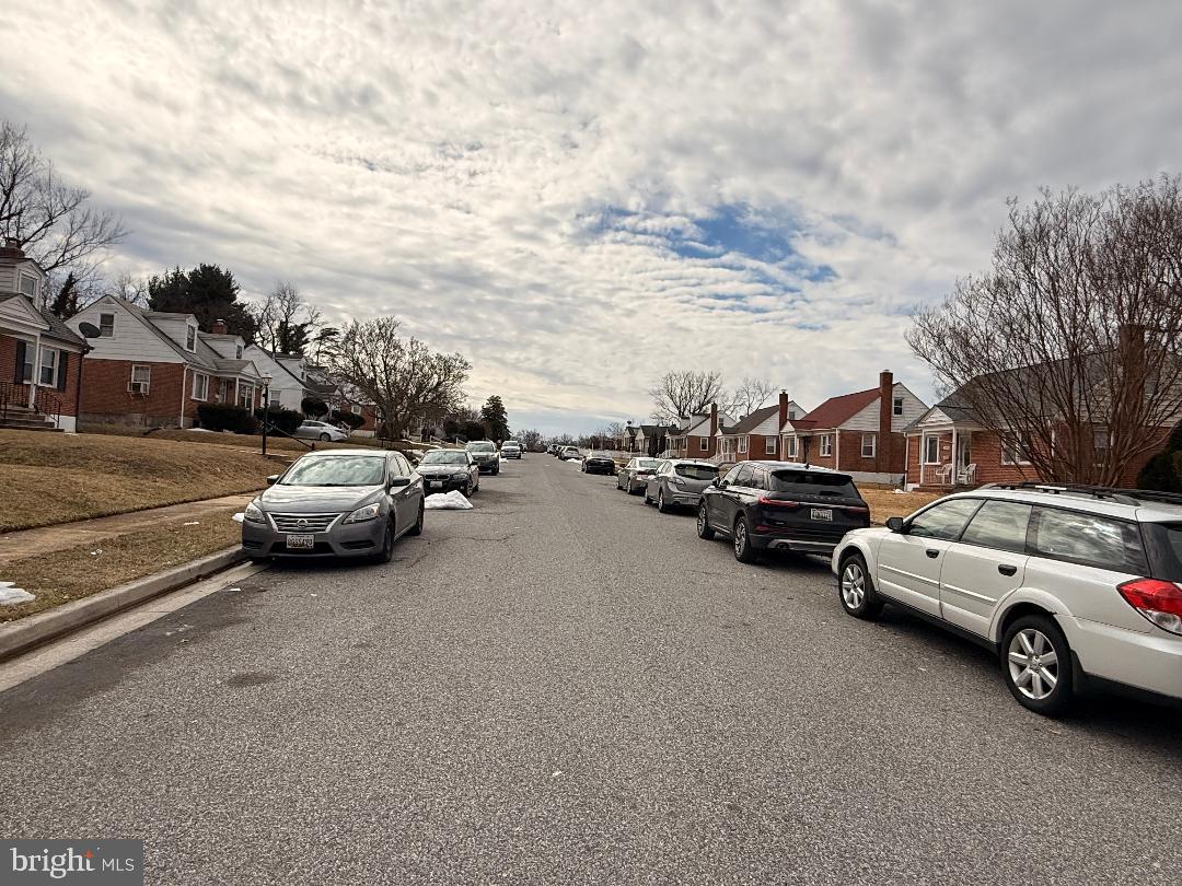 3499 Hillsmere Road Baltimore, MD 21207 - Photo 50 of 50 Quiet suburban street under a cloudy sky.