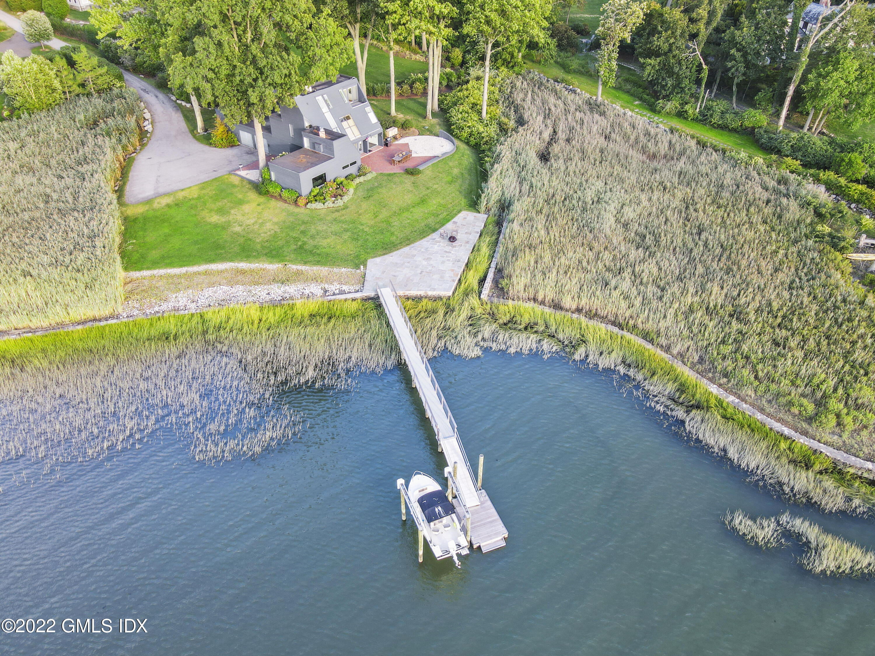 46 Carriglea Drive Riverside, CT 06878 - Photo 6 of 41 a backyard of a house with a yard and outdoor seating