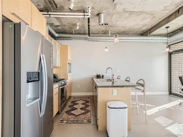 a kitchen with a sink a stove and refrigerator