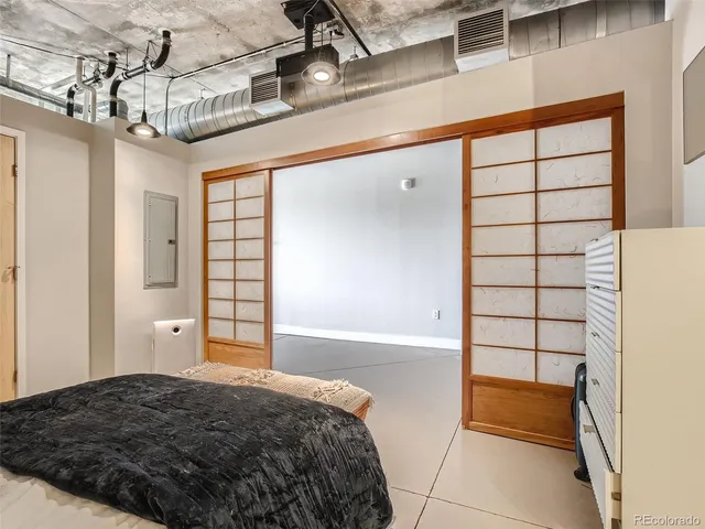 a bedroom with a bed and window