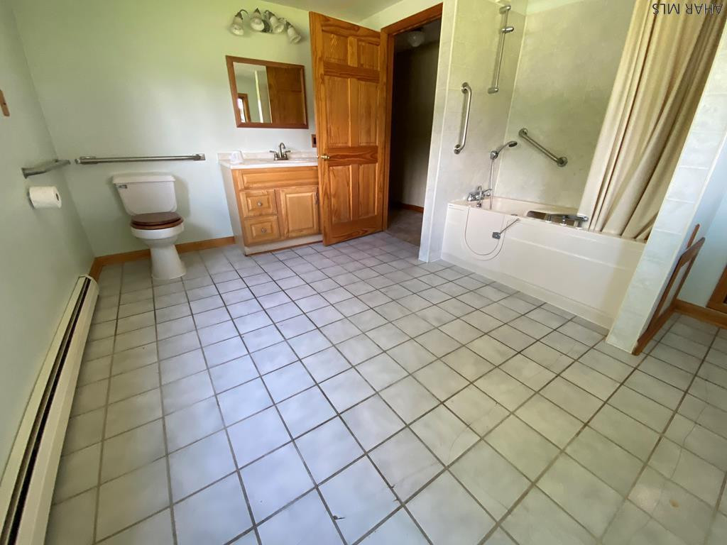 1648 Allegheny Road Manns Choice, PA 15550 - Photo 26 of 53 a bathroom with a sink a toilet and mirror