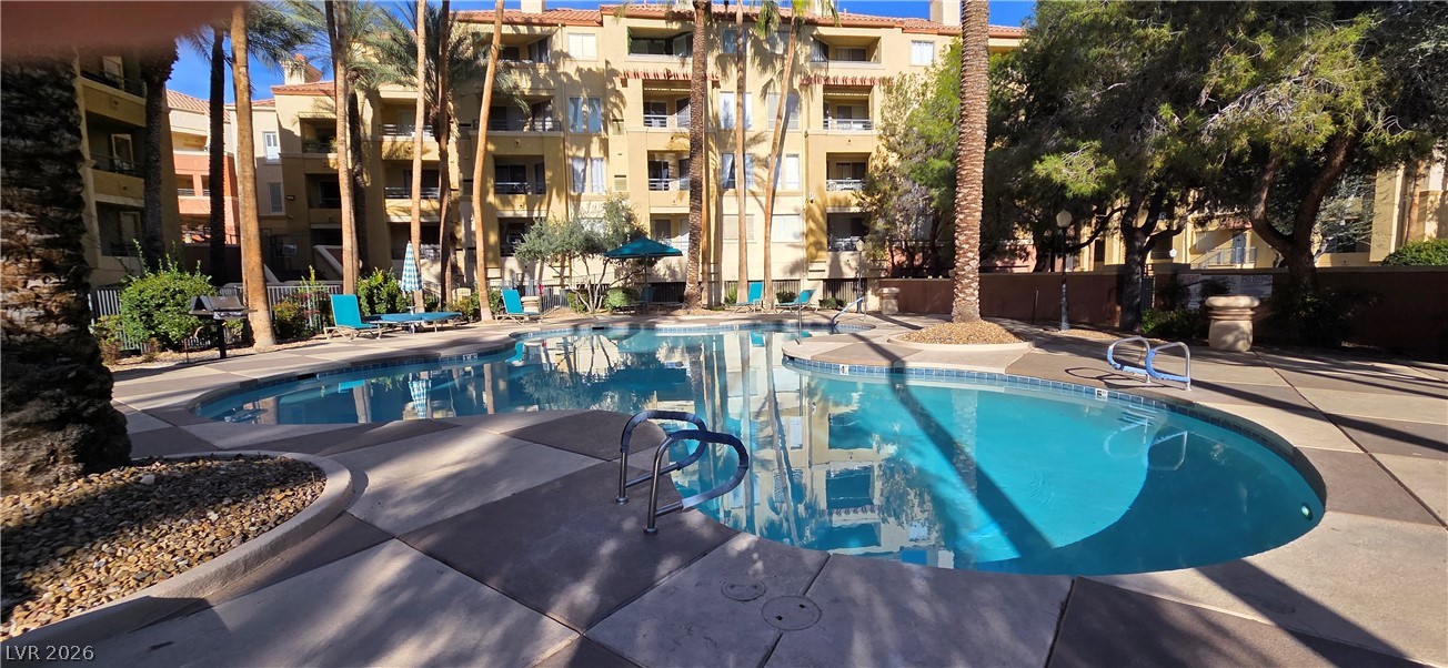 210 East Flamingo Road, Unit 208 Las Vegas, NV 89169 - Photo 30 of 42 A tranquil oasis awaits with this community pool, surrounded by lush palms and inviting lounge areas.