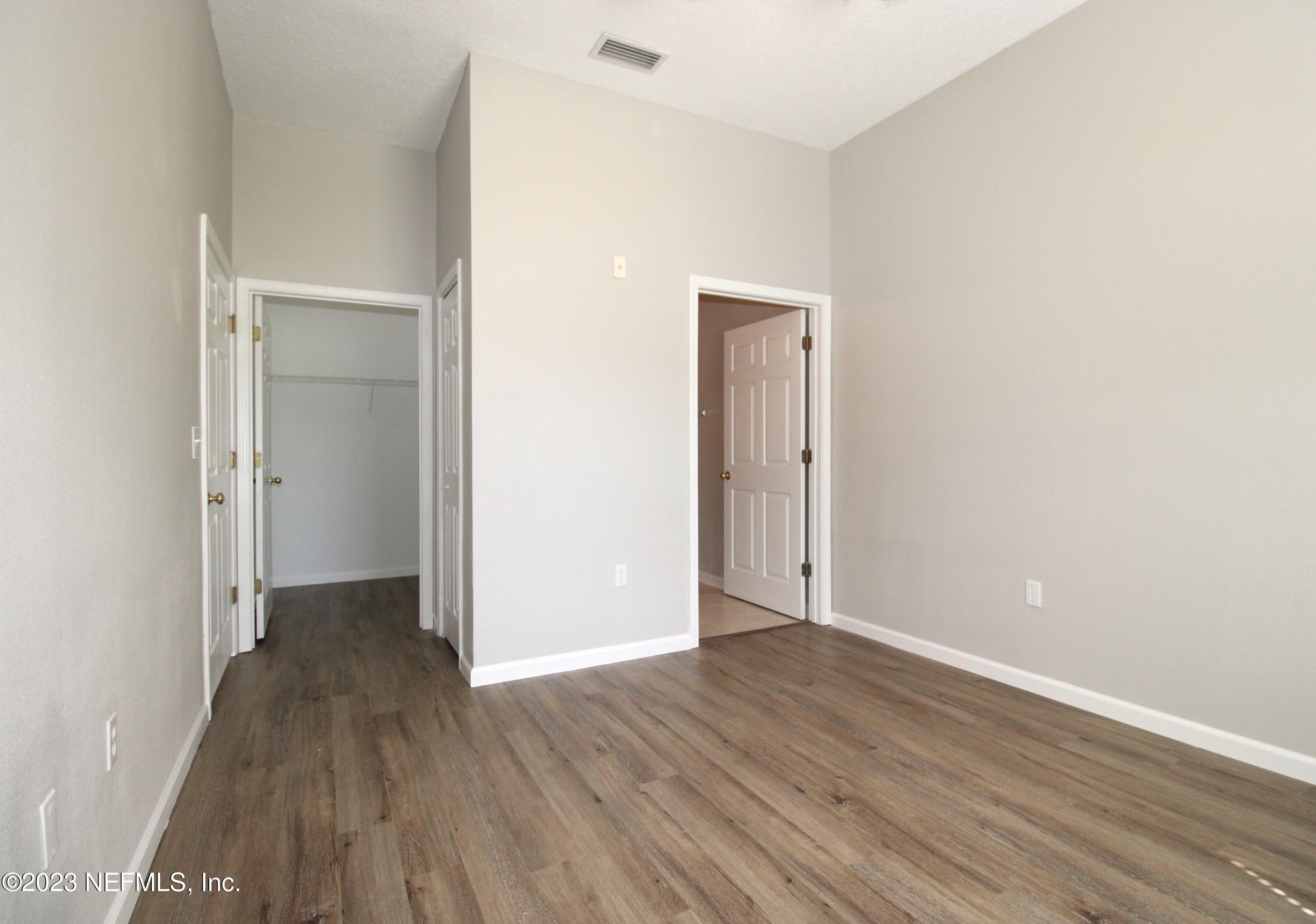 416 Golden Lake Loop St. Augustine, FL 32084 - Photo 11 of 22 a view of an empty room with wooden floor
