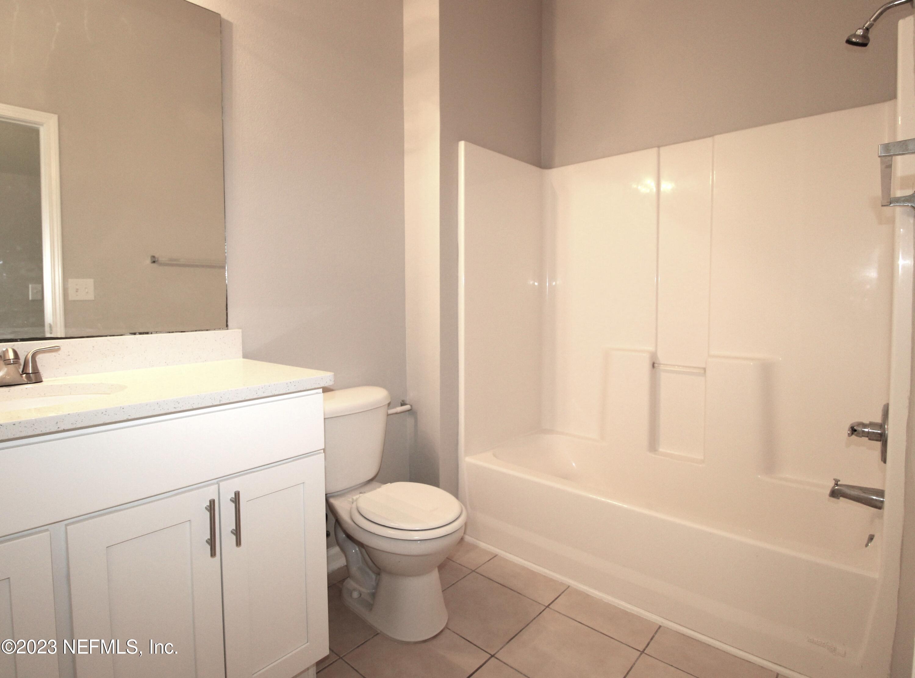 416 Golden Lake Loop St. Augustine, FL 32084 - Photo 15 of 22 a bathroom with a sink a toilet and shower