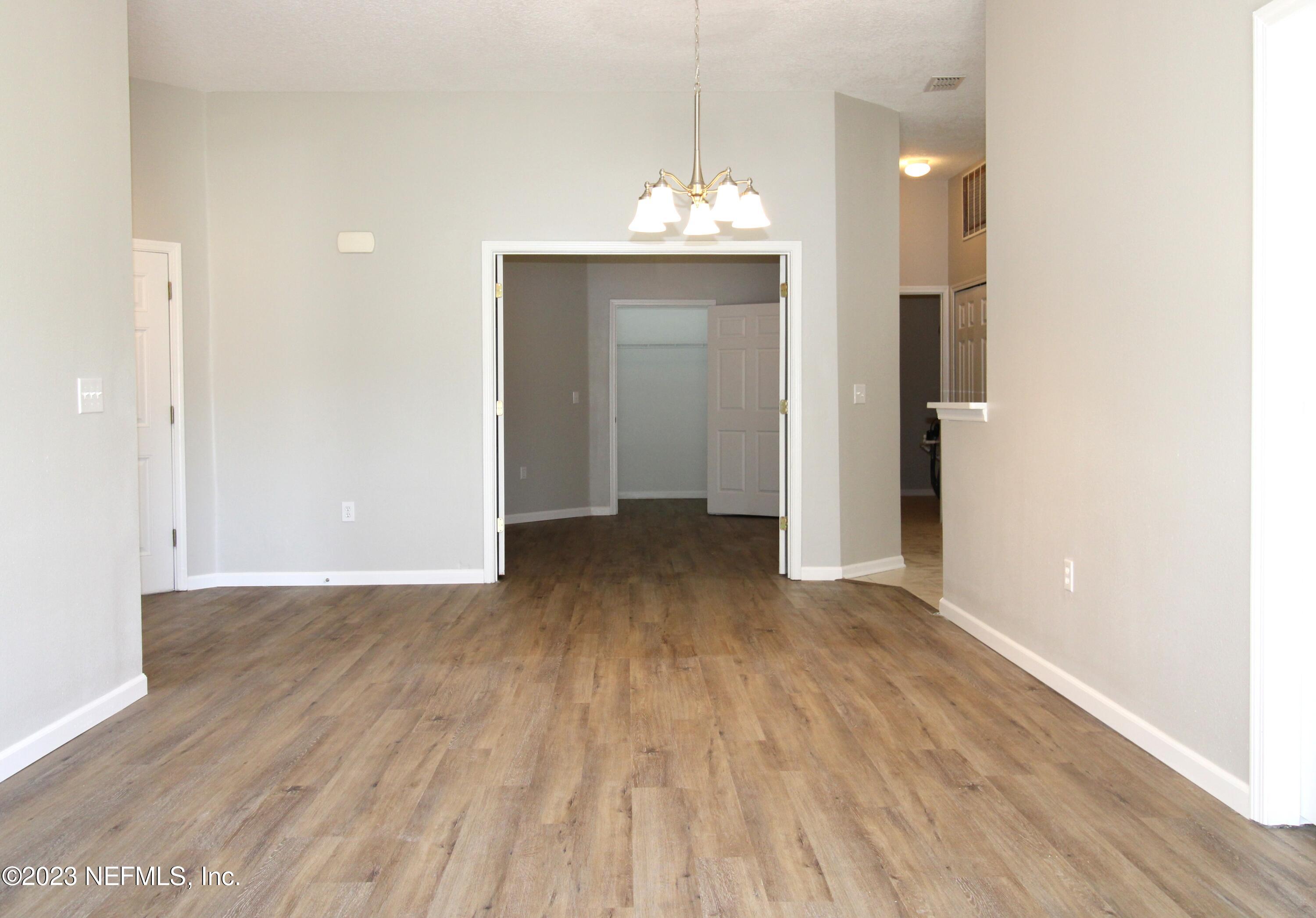 416 Golden Lake Loop St. Augustine, FL 32084 - Photo 2 of 22 a view of a room with wooden floor and a ceiling fan