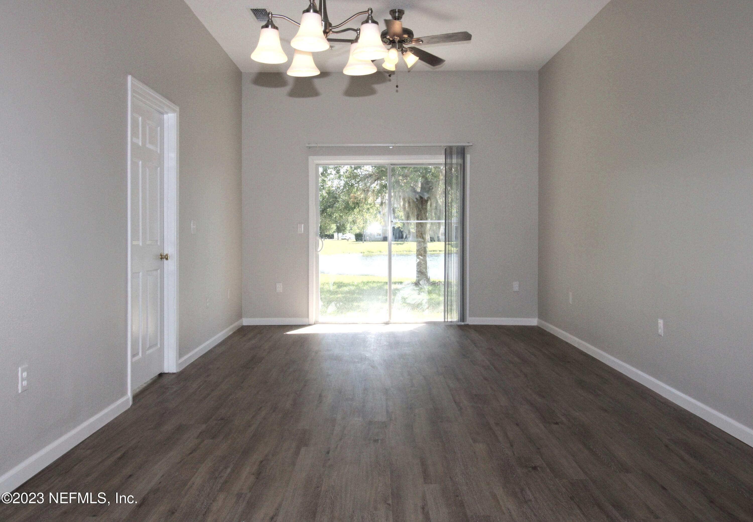 416 Golden Lake Loop St. Augustine, FL 32084 - Photo 3 of 22 a view of an empty room with wooden floor and a window