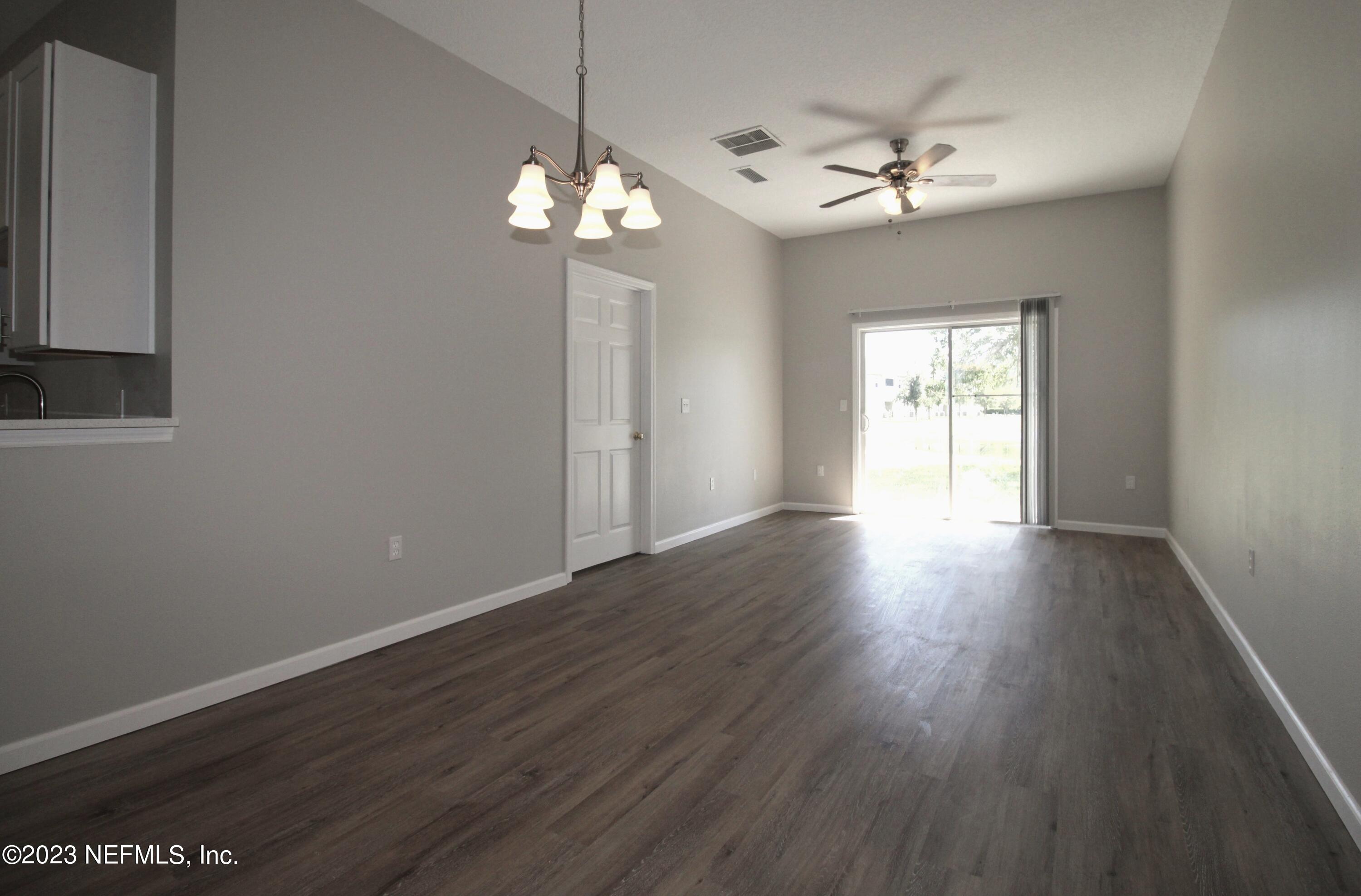 416 Golden Lake Loop St. Augustine, FL 32084 - Photo 5 of 22 a view of an empty room with wooden floor and a window