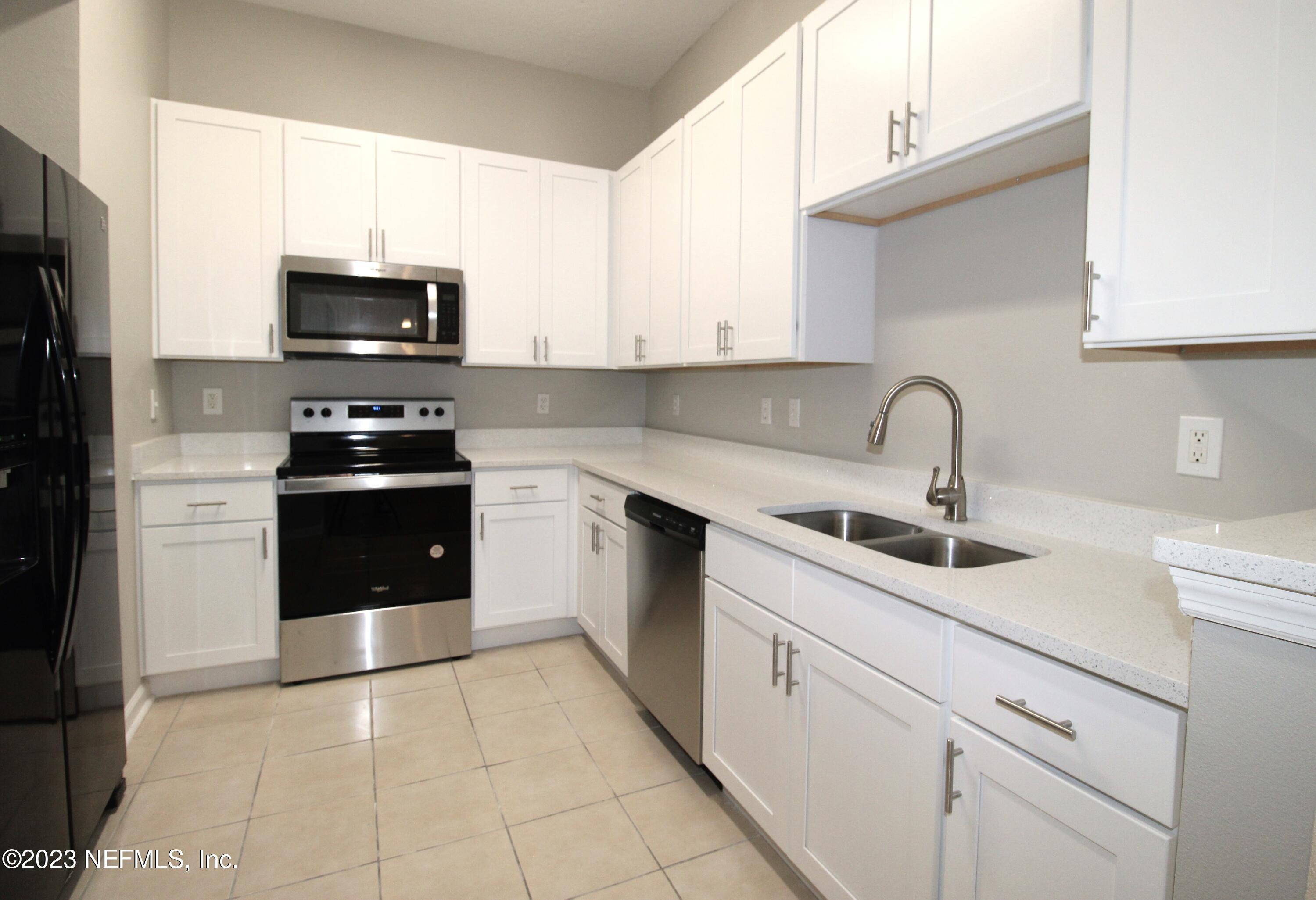 416 Golden Lake Loop St. Augustine, FL 32084 - Photo 9 of 22 a kitchen with stainless steel appliances granite countertop a sink and a stove