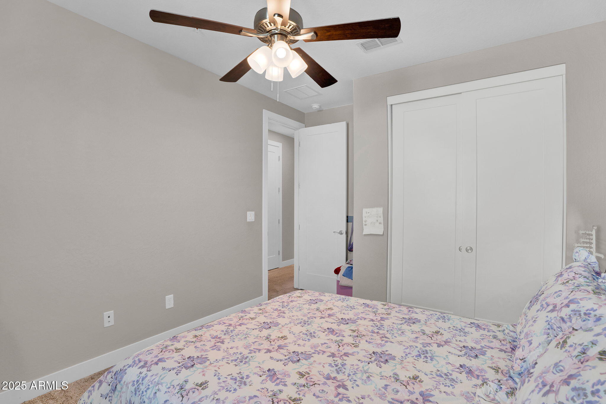 3855 South McQueen Road, Unit 73 Chandler, AZ 85286 - Photo 17 of 24 a bedroom with a bed and a chandelier