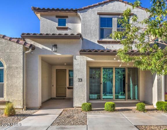 3855 South McQueen Road, Unit 73 Chandler, AZ 85286 - Photo 2 of 24 a front view of a house with garden