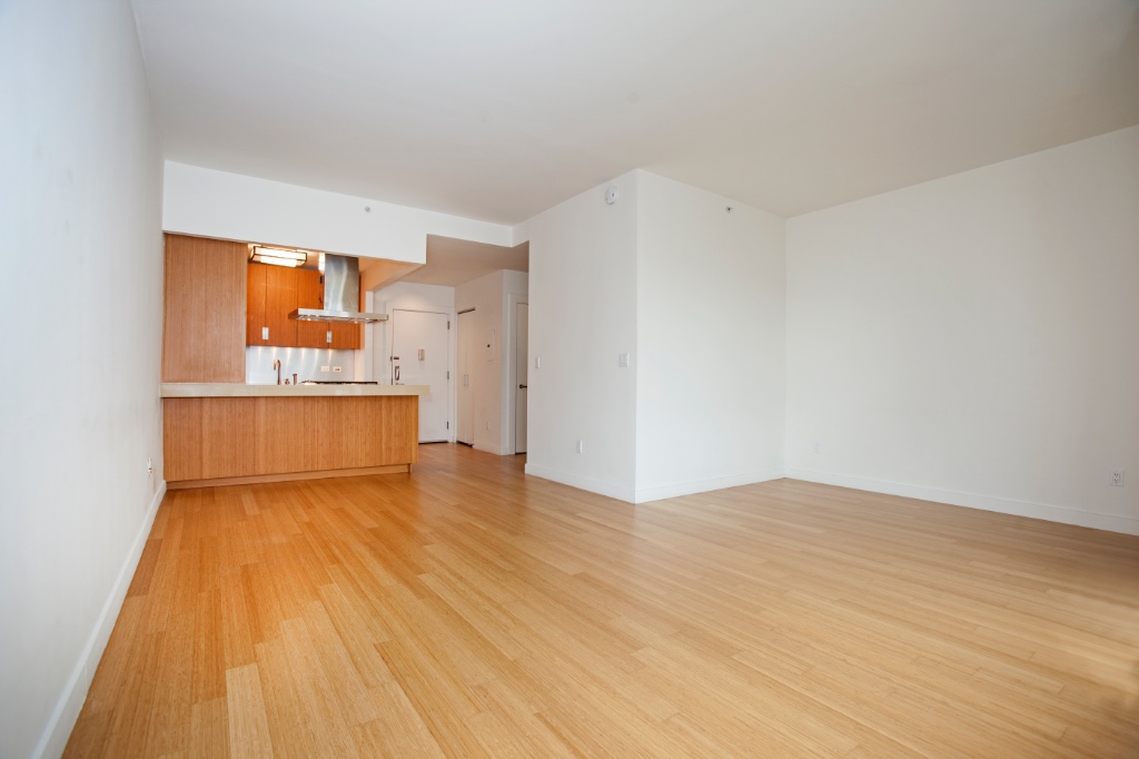 450 West 17th Street, Unit 1014 Manhattan, NY 10011 - Photo 2 of 7 a view of a room with wooden floor and a sink