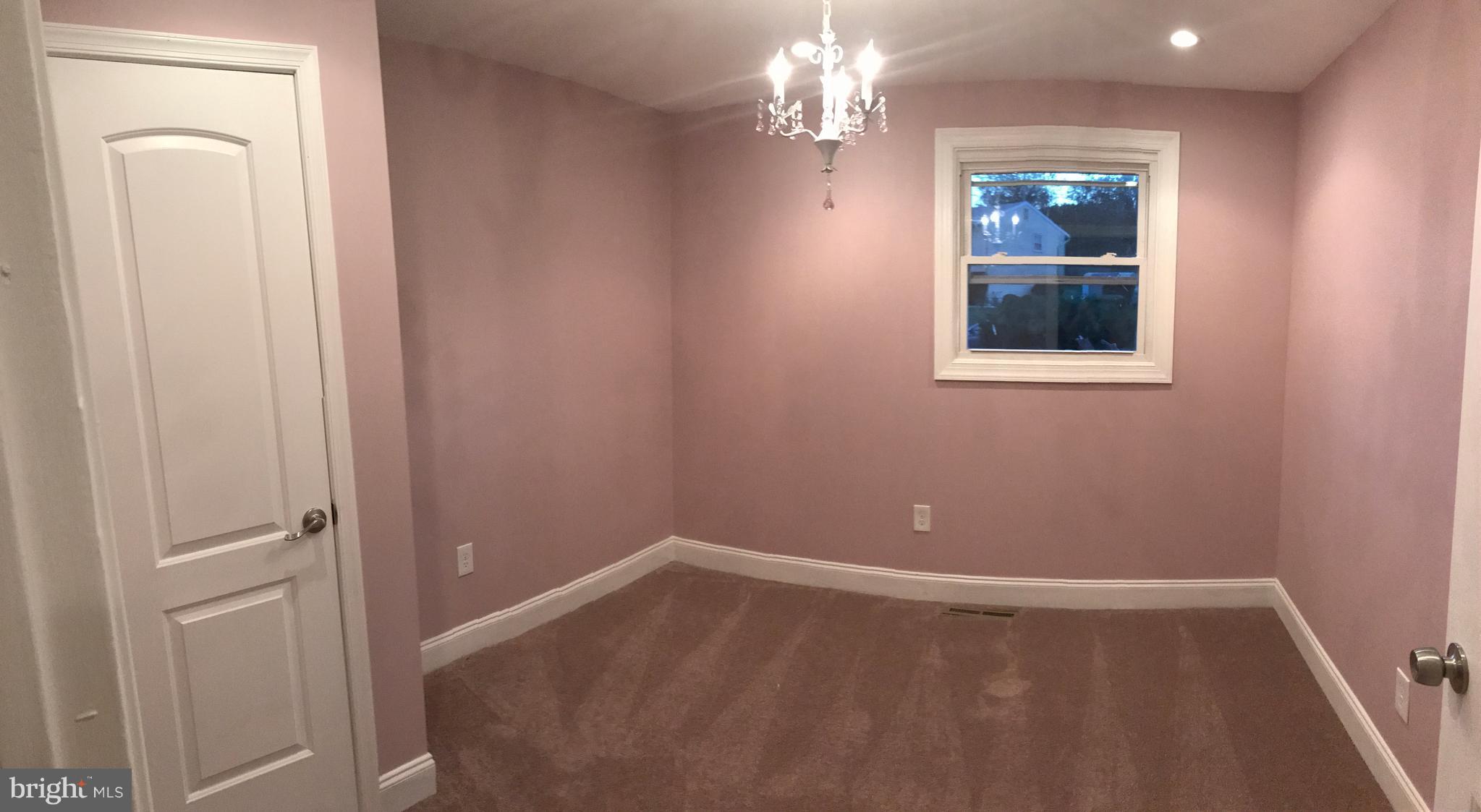 6710 Fox Meadow Road Baltimore, MD 21207 - Photo 11 of 24 a view of an empty room with window and wooden floor
