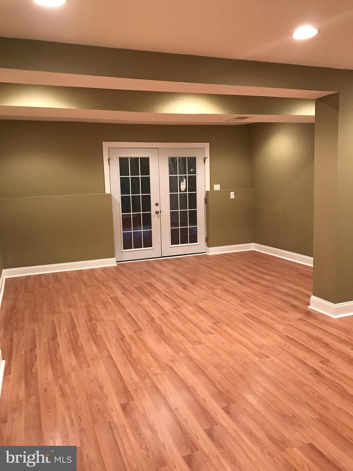 6710 Fox Meadow Road Baltimore, MD 21207 - Photo 12 of 24 a view of an empty room with wooden floor and a window