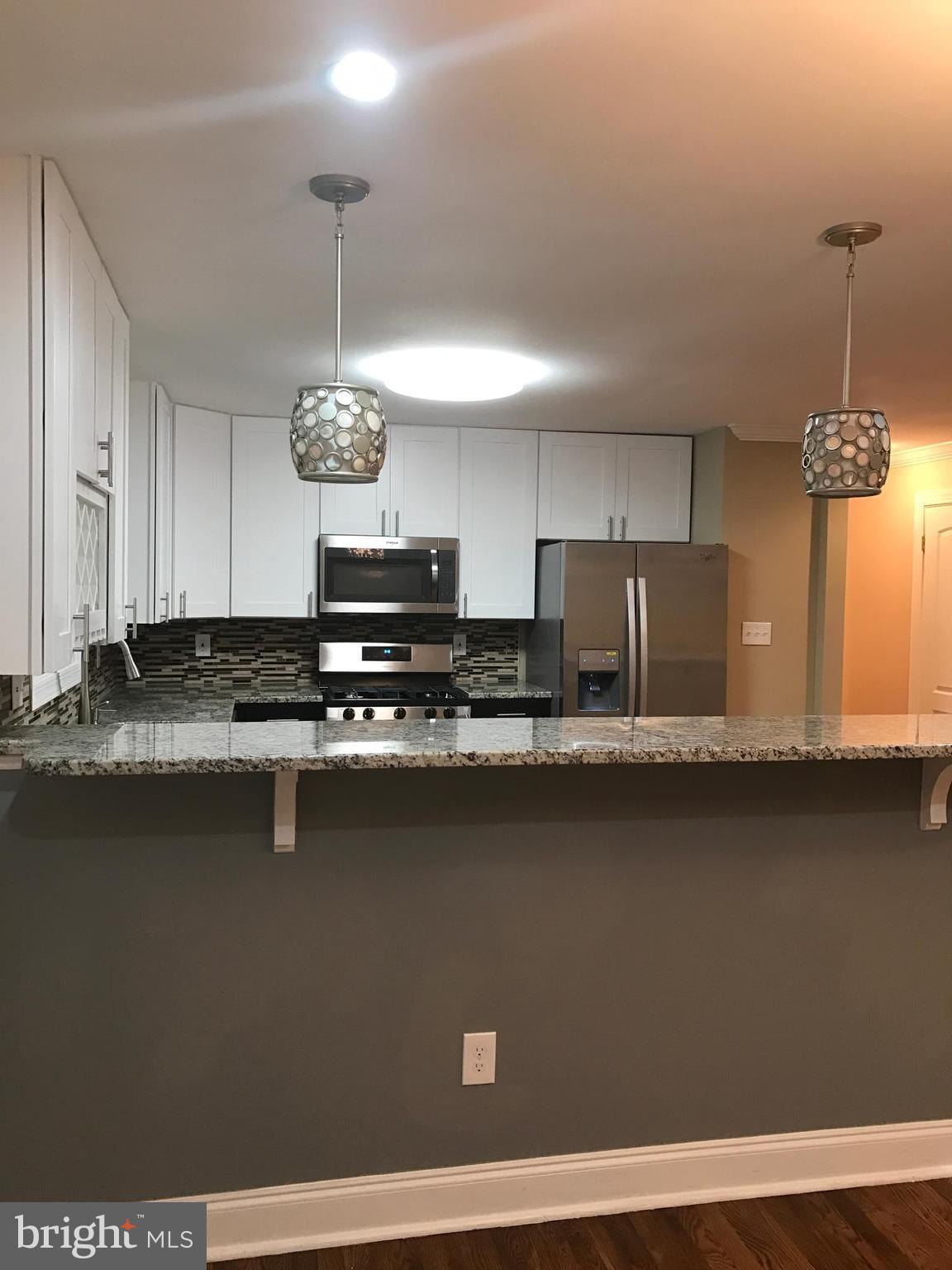 6710 Fox Meadow Road Baltimore, MD 21207 - Photo 3 of 24 a kitchen with stainless steel appliances granite countertop a sink a stove and a granite counter tops