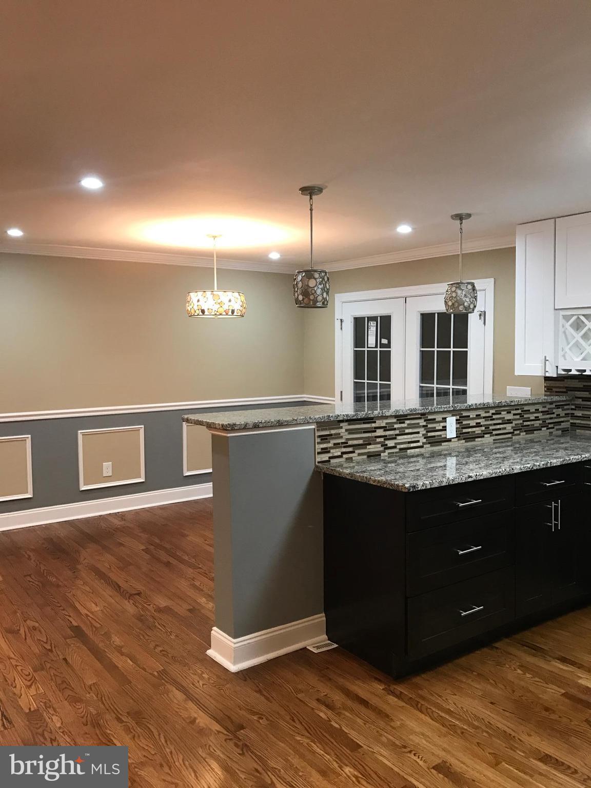 6710 Fox Meadow Road Baltimore, MD 21207 - Photo 4 of 24 a view of kitchen with granite countertop window and wooden floor