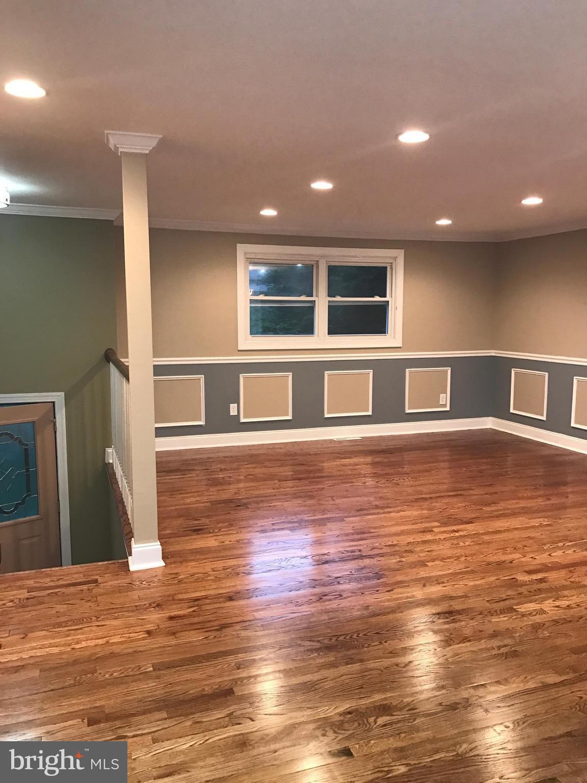 6710 Fox Meadow Road Baltimore, MD 21207 - Photo 5 of 24 a big room with wooden floor and windows