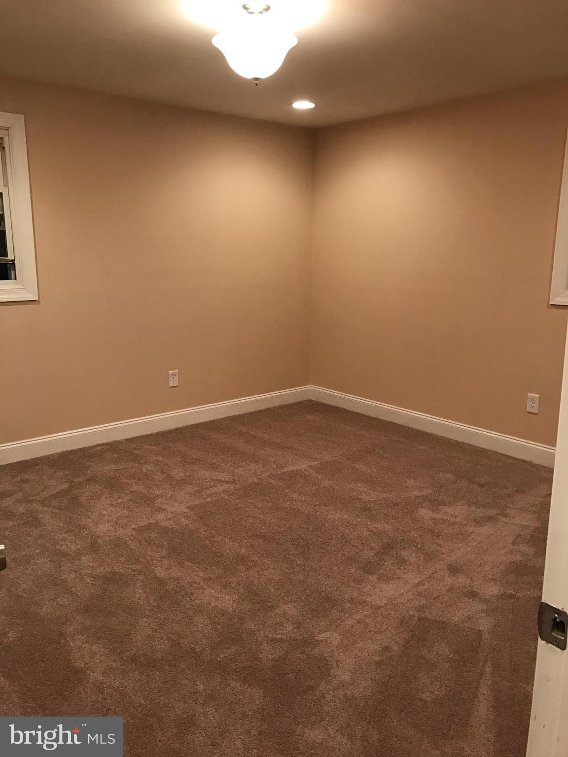 6710 Fox Meadow Road Baltimore, MD 21207 - Photo 8 of 24 an empty room with a natural light