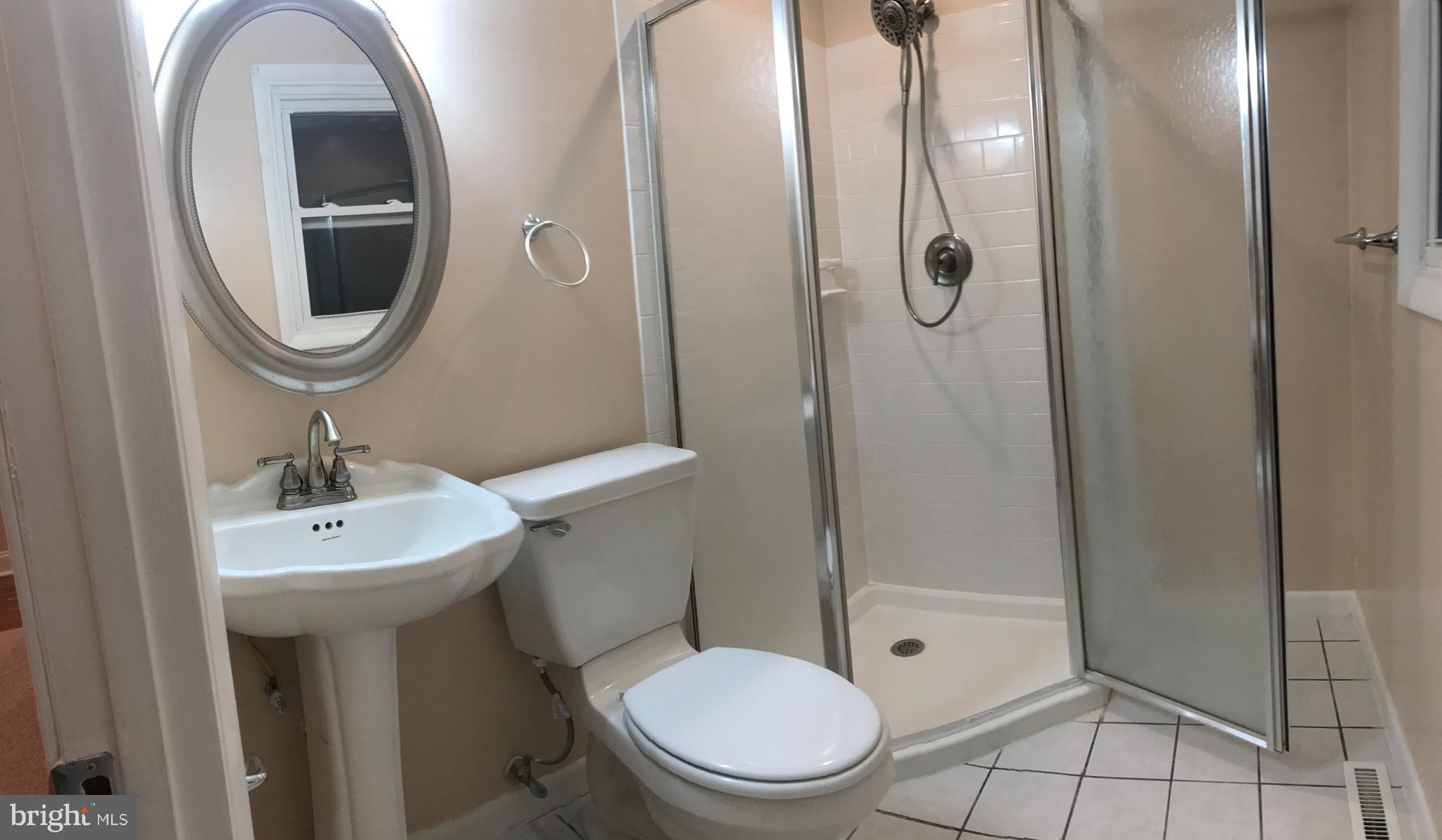 6710 Fox Meadow Road Baltimore, MD 21207 - Photo 9 of 24 a bathroom with a toilet a sink and shower