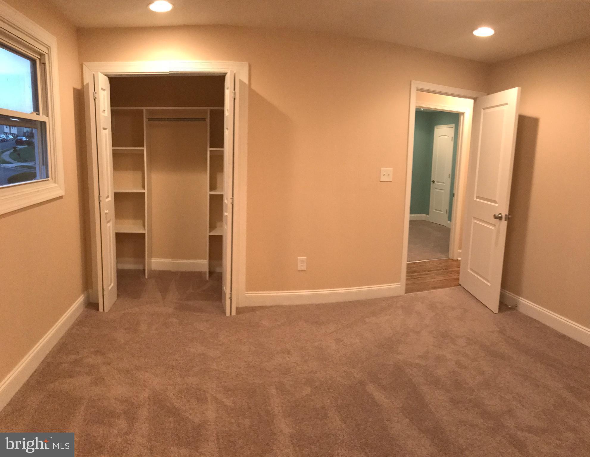 6710 Fox Meadow Road Baltimore, MD 21207 - Photo 10 of 24 an empty room with closet and wooden door