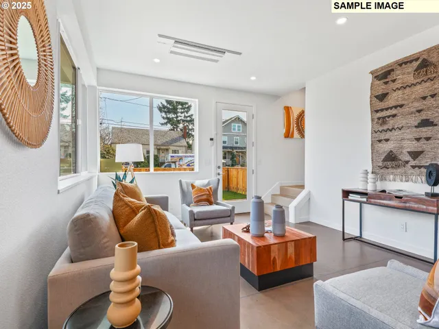 a living room with fireplace furniture and a large window