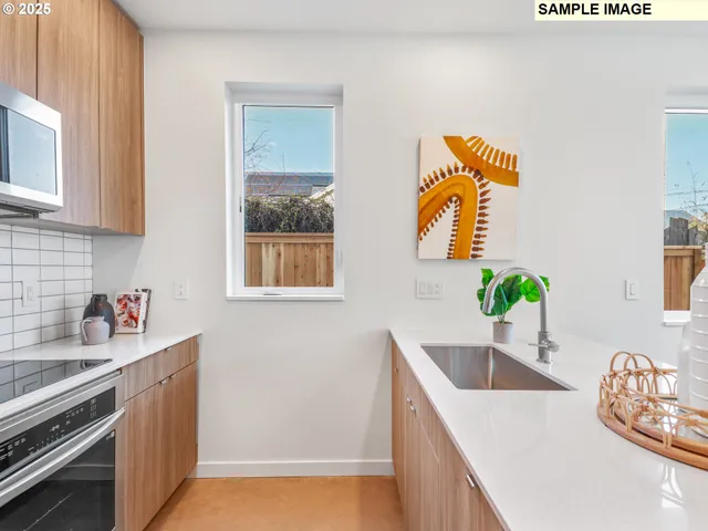 a kitchen with stainless steel appliances granite countertop a sink a stove and a wooden cabinets
