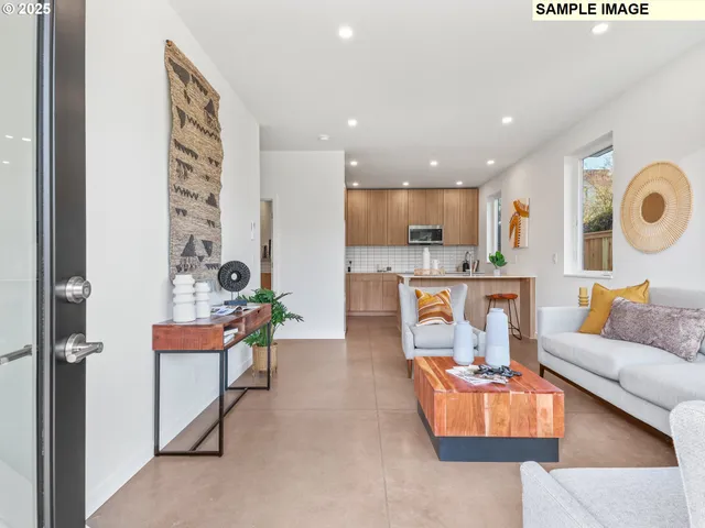 a living room with furniture and kitchen view