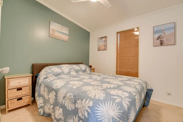 a large bed sitting in a bedroom next to a window