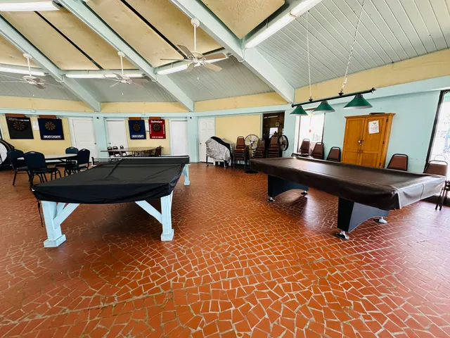 a view of a patio with dining table and chairs under an umbrella