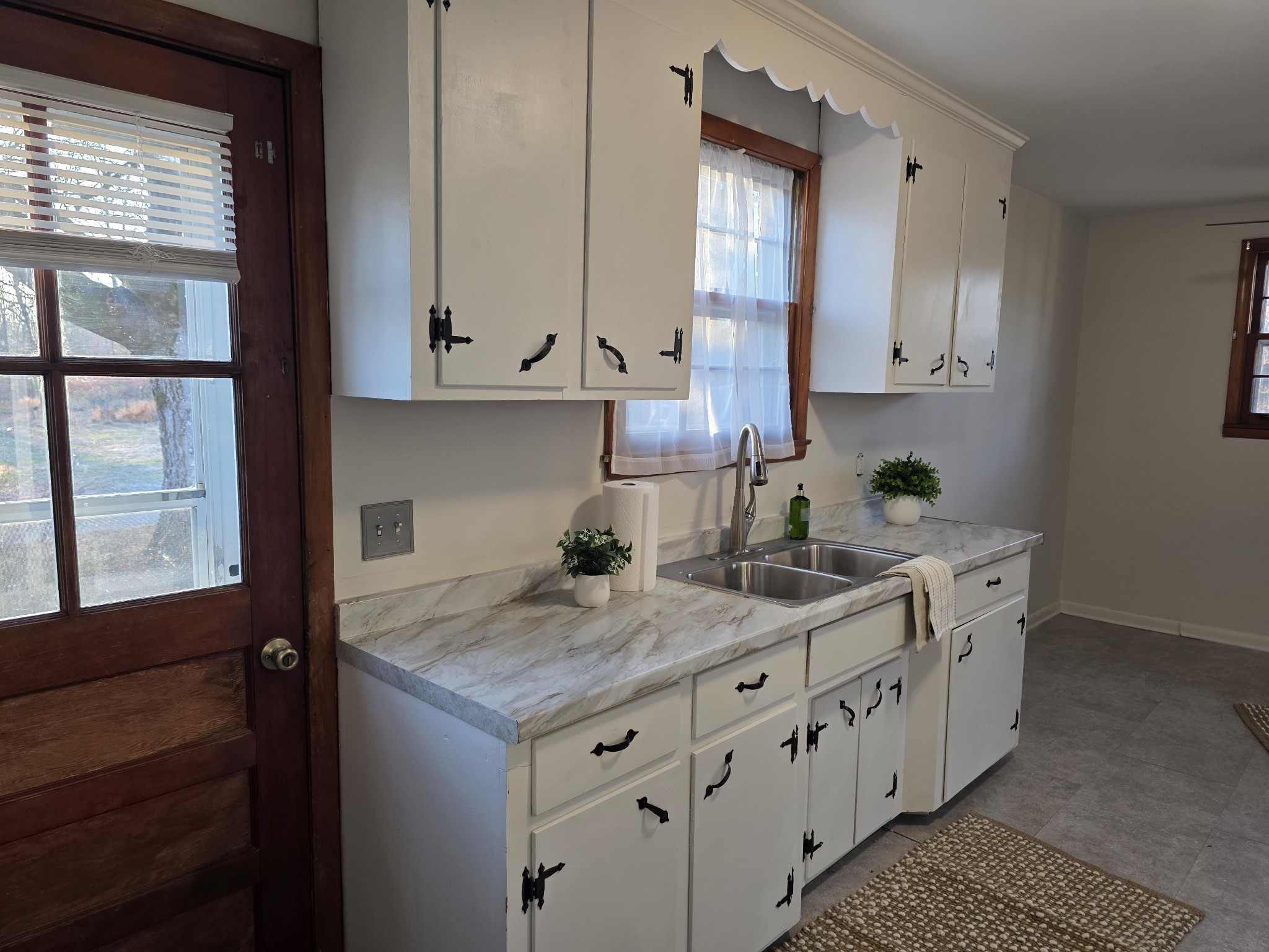 1497 Mt Pleasant Road Kingston Springs, TN 37082 - Photo 12 of 25 a kitchen with granite countertop white cabinets and white appliances