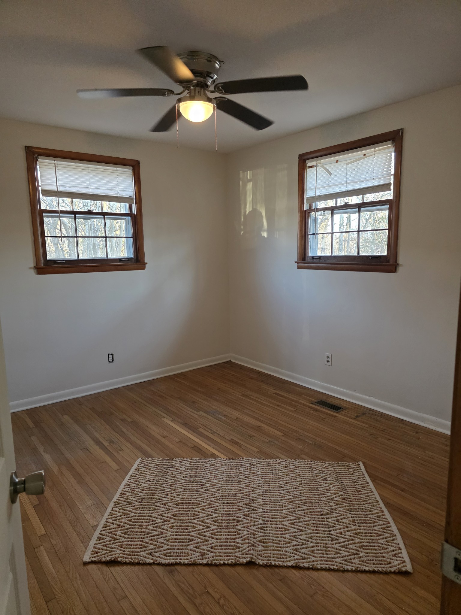 1497 Mt Pleasant Road Kingston Springs, TN 37082 - Photo 18 of 25 an empty room with wooden floor fan and windows