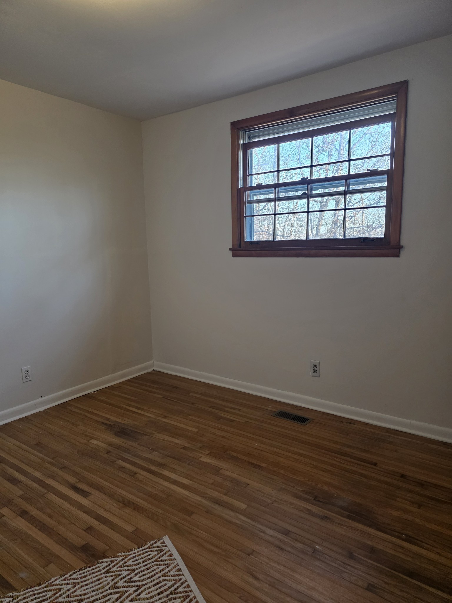 1497 Mt Pleasant Road Kingston Springs, TN 37082 - Photo 19 of 25 a view of an empty room with wooden floor and a window