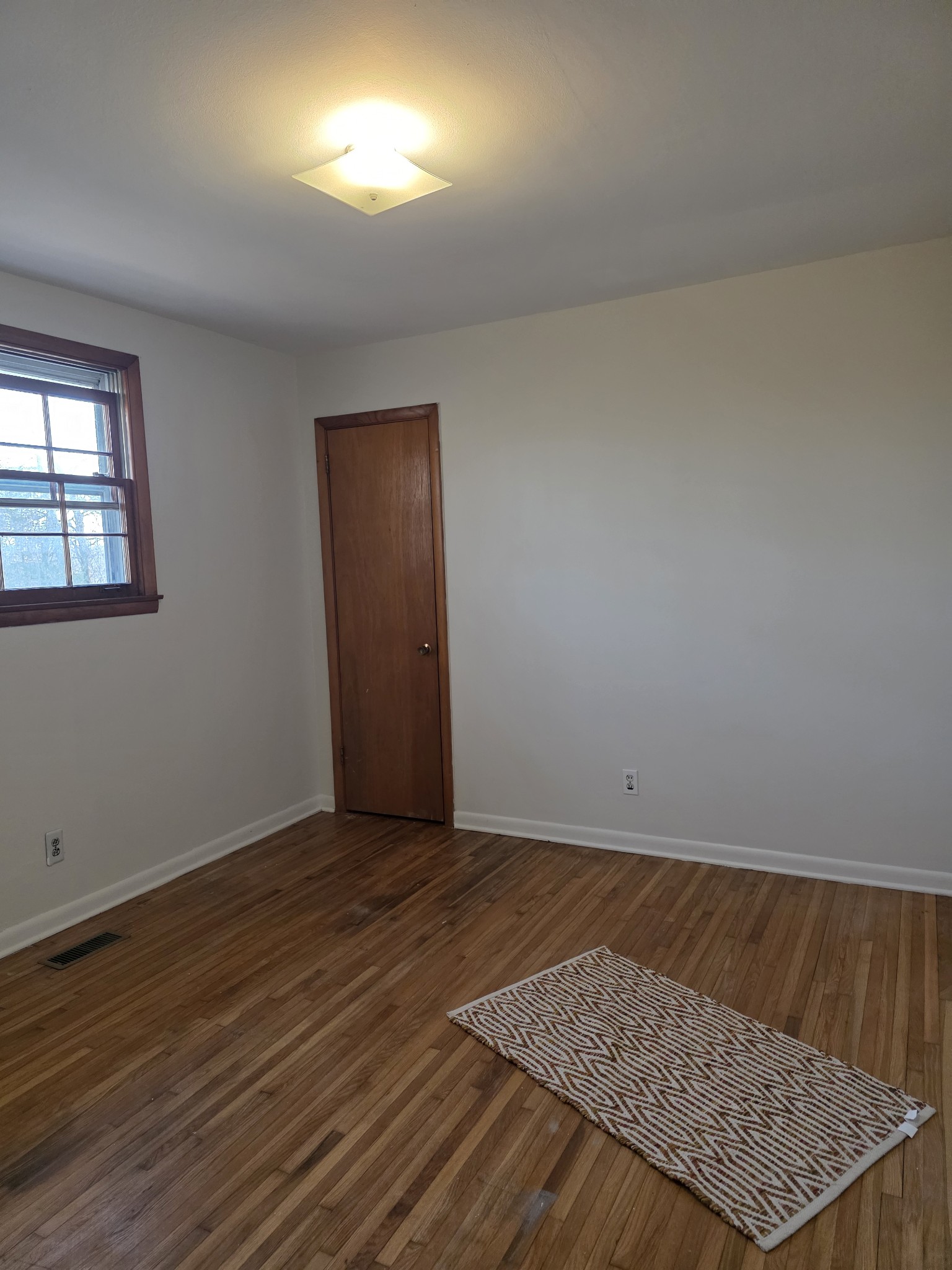 1497 Mt Pleasant Road Kingston Springs, TN 37082 - Photo 22 of 25 an empty room with wooden floor and windows