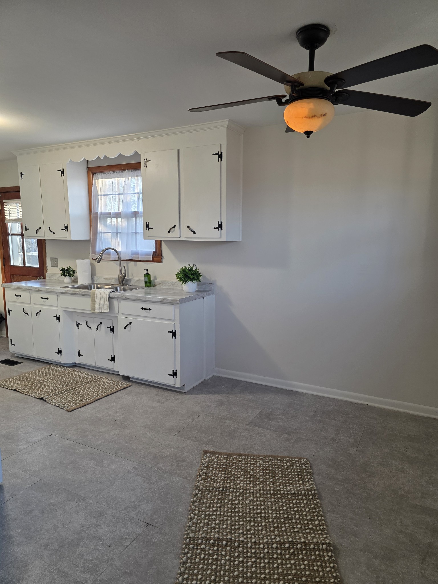 1497 Mt Pleasant Road Kingston Springs, TN 37082 - Photo 7 of 25 a kitchen with granite countertop a sink stainless steel appliances and cabinets